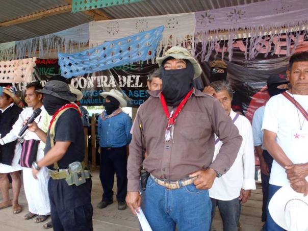 Moisés (with mic), Tacho (in forefront) and Galeano (aka Marcos) in the back address indigenous meeting in La Realidad