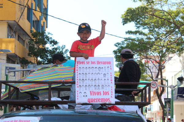 During demonstrations over Ayotzinapa, a young man raises a Zapatista (left) fist.