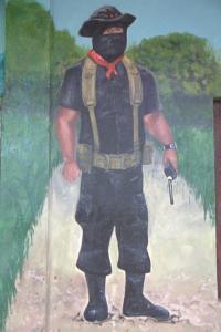 Subcomandante Moisés holding his radio in a La Realidad Mural